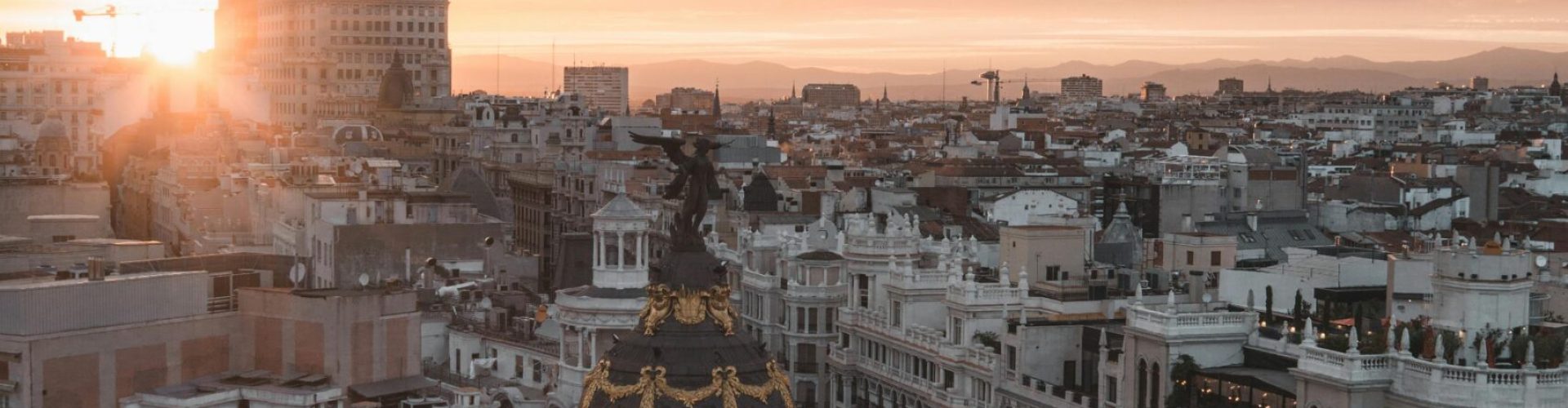 Stunning view of Madrid cityscape with sunset over the Metropolis Building.